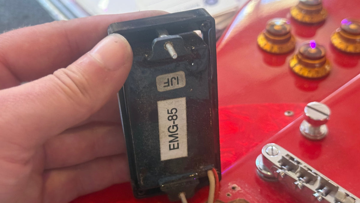 Modified Epiphone Firebird — underside of pickup showing EMG-85 model label