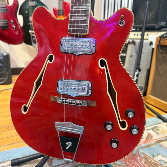 Front body view showing cherry finish, two Fender-branded pickups, four controls and missing pickguard